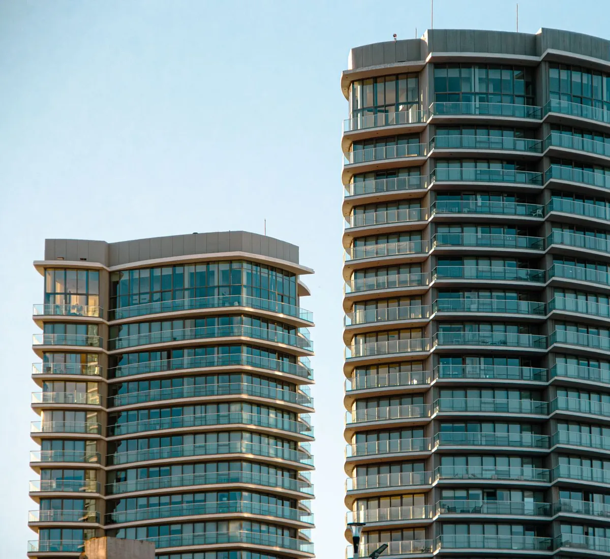 Glass-clad residential and commercial towers seen from below